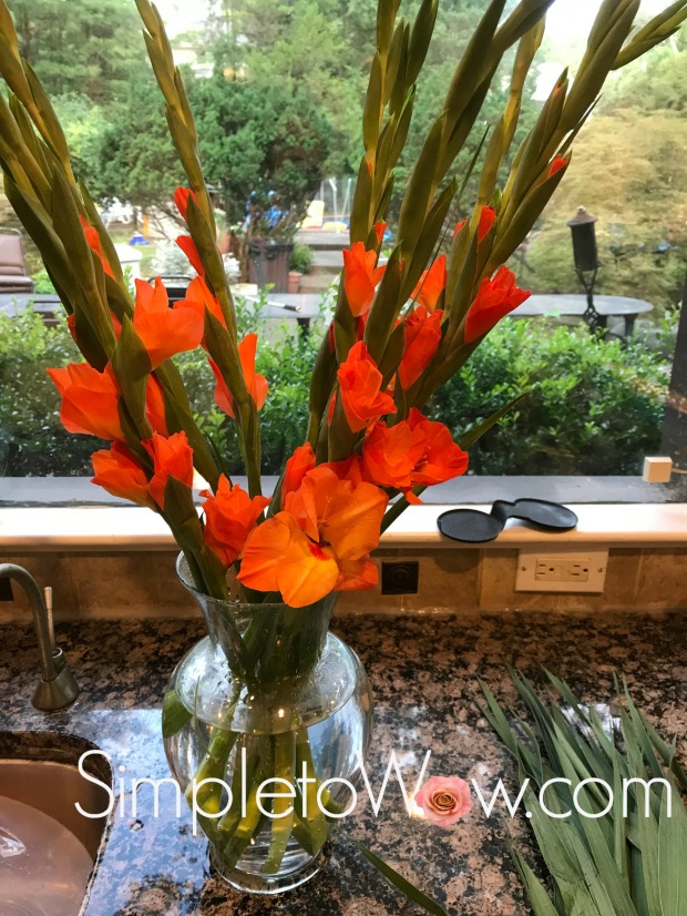 orange gladiolas in vase